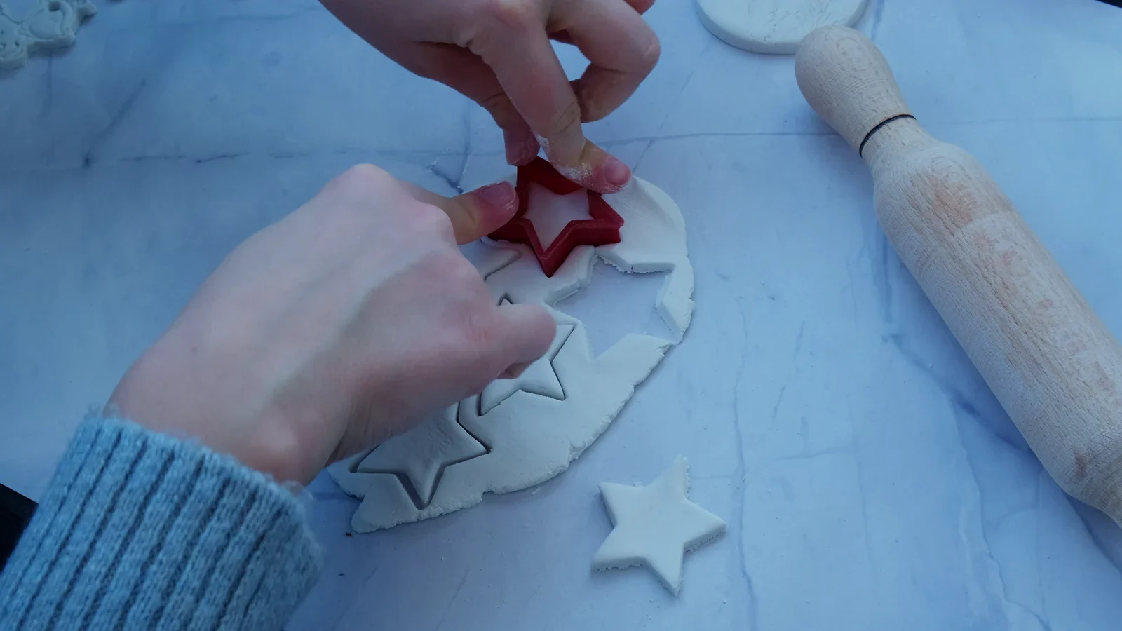Star cutter pressed into a sheet of white modelling clay.