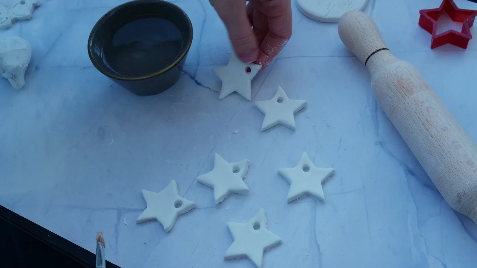 White clay stars lying flat and apart on a work surface.
