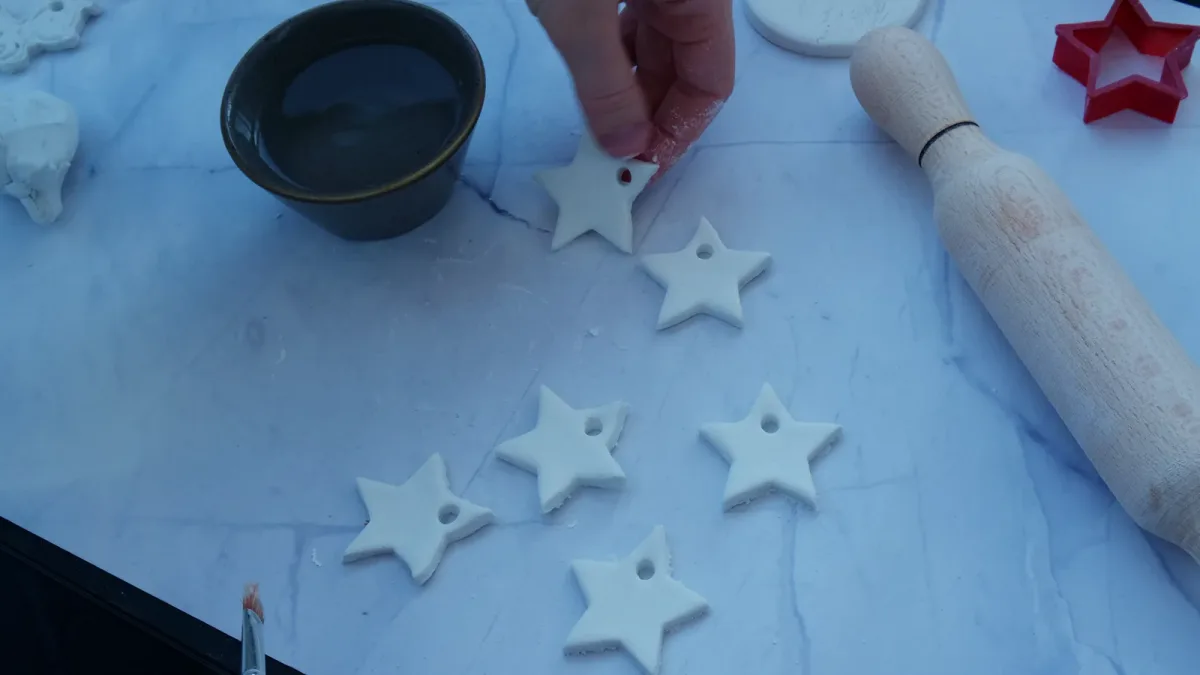 White clay stars lying flat and apart on a work surface.